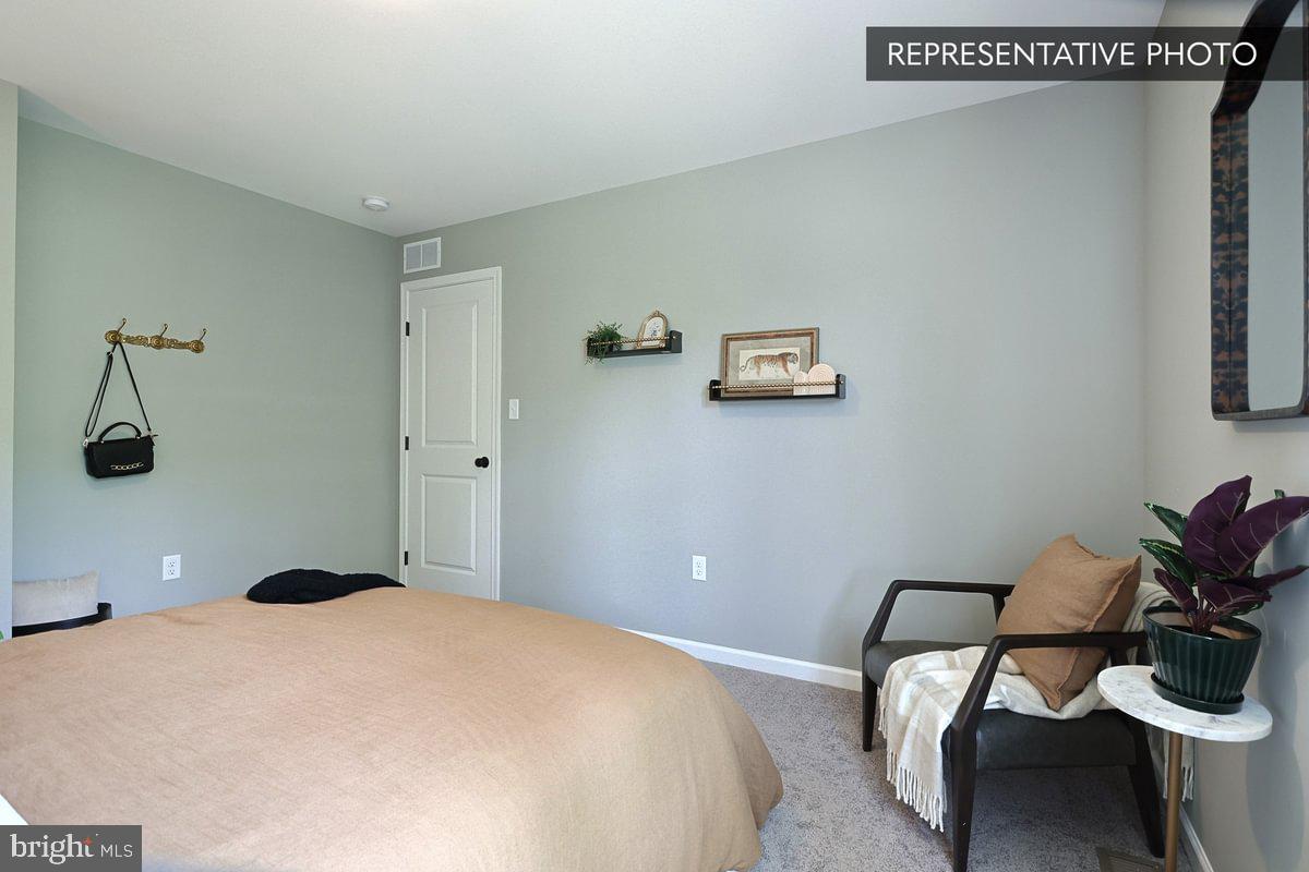 Sweet Birch Plan At Hills Spring Grove, PA 17362 - Photo 39 of 47 a bedroom with a bed and a chair