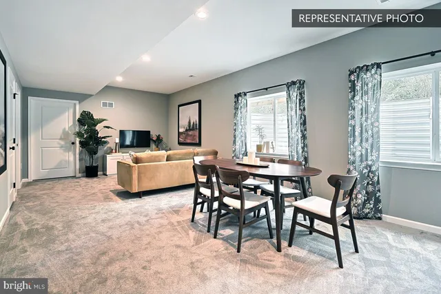 a living room with furniture a fireplace and a table