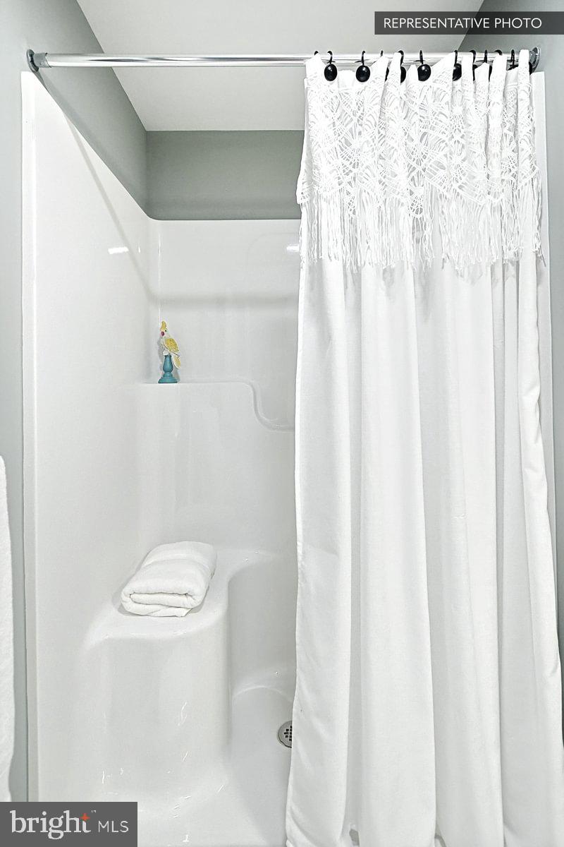 Sweet Birch Plan At Hills Spring Grove, PA 17362 - Photo 46 of 47 a white toilet sitting next to a shower curtain