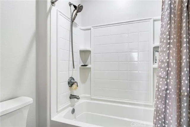 a bathroom with a shower and a toilet