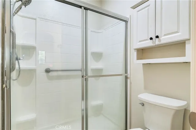 a bathroom with a shower and a toilet