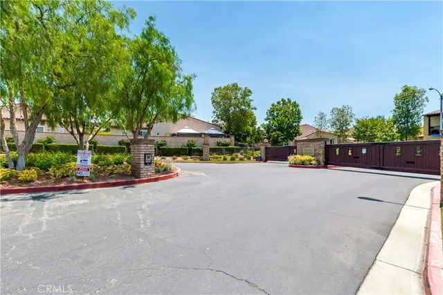 a view of swimming pool with outdoor seating and trees in the background