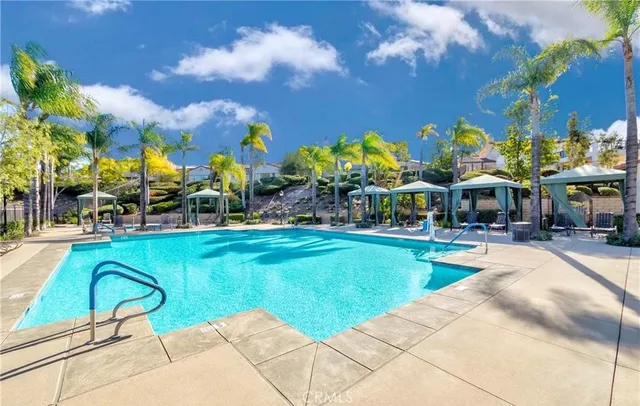 a swimming pool with outdoor seating and yard