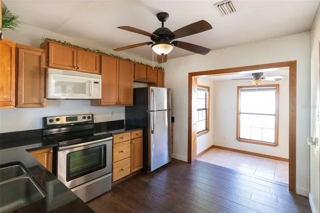 a kitchen with stainless steel appliances a stove a refrigerator sink and cabinets