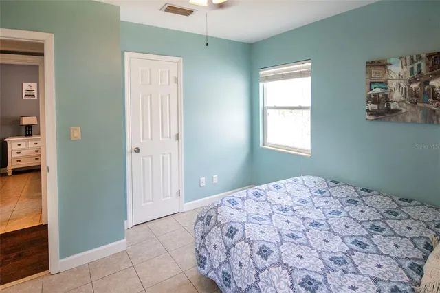 a bedroom with a bed and a window