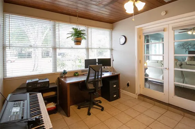 a view of a workspace with furniture and a window