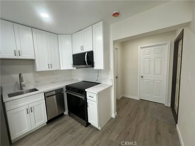 a kitchen with a sink stove and cabinets