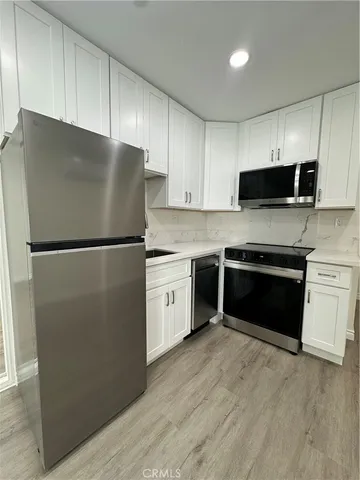 a kitchen with a refrigerator stove and microwave
