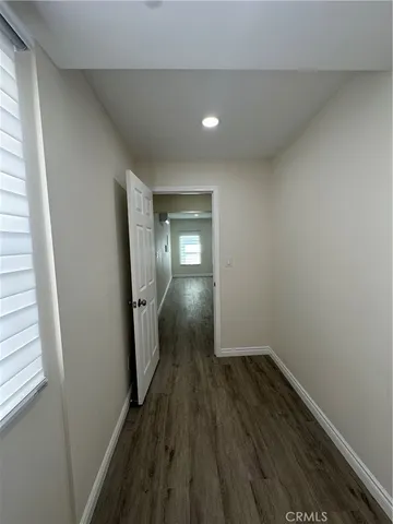a view of hallway with wooden floor