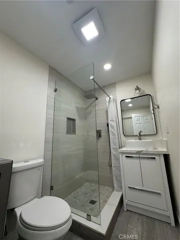 a bathroom with a toilet a sink and shower