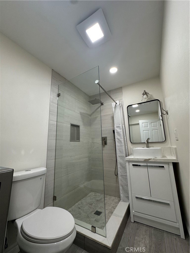 20655 Lemmer Street Chatsworth, CA 91311 - Photo 17 of 25 a bathroom with a toilet a sink and shower
