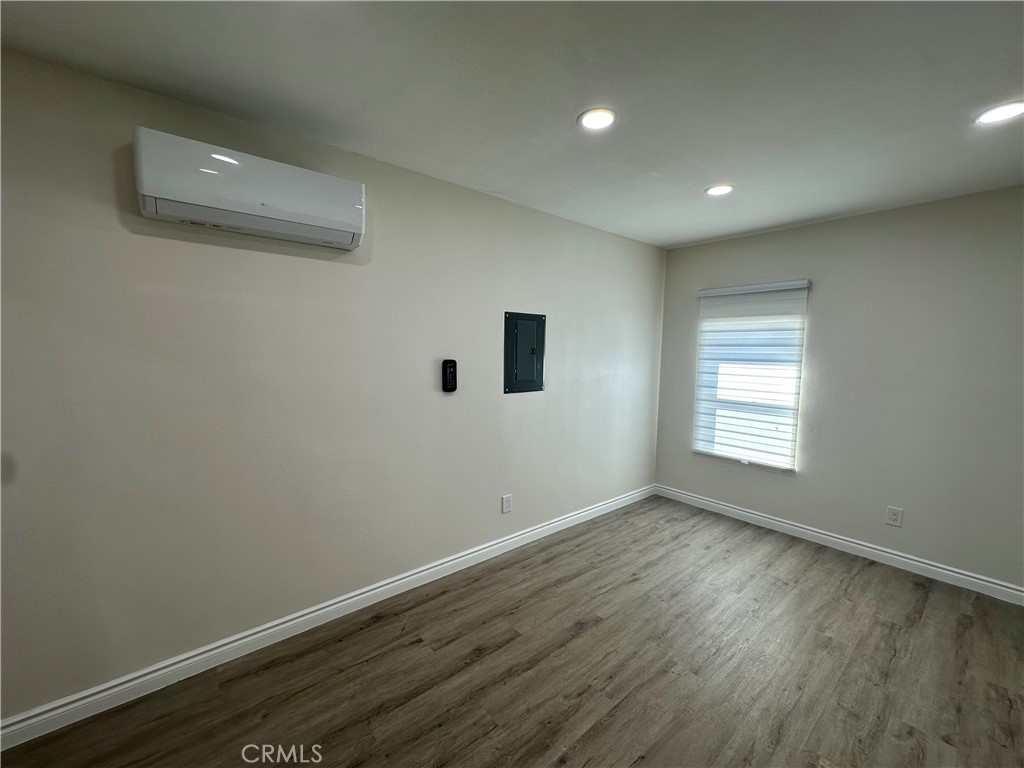 20655 Lemmer Street Chatsworth, CA 91311 - Photo 5 of 25 an empty room with wooden floor and windows