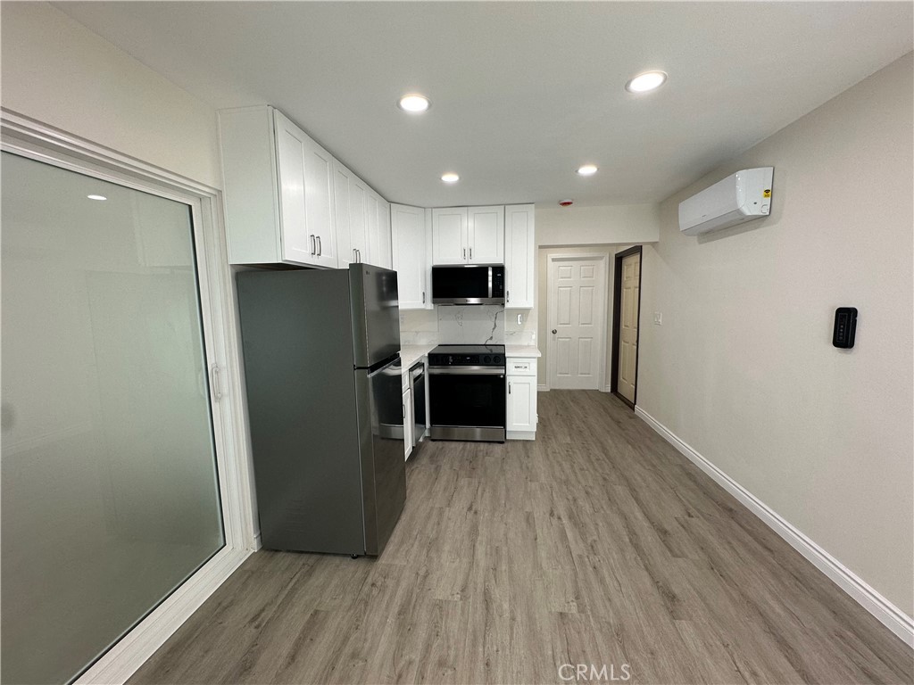 20655 Lemmer Street Chatsworth, CA 91311 - Photo 8 of 25 a kitchen with stainless steel appliances a refrigerator and a stove top oven