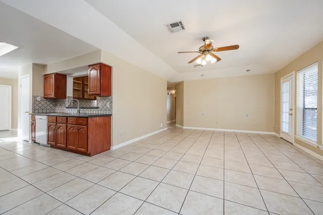 a kitchen with stainless steel appliances a refrigerator and microwave