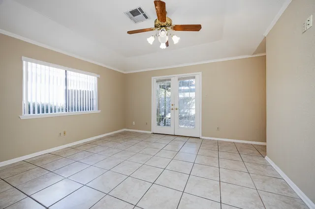 an empty room with closet and windows
