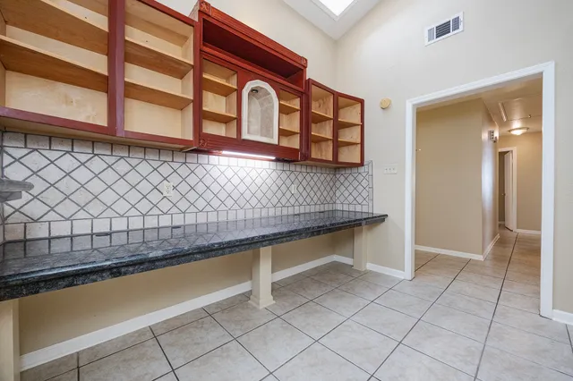 a kitchen with stainless steel appliances granite countertop a stove a microwave and a sink