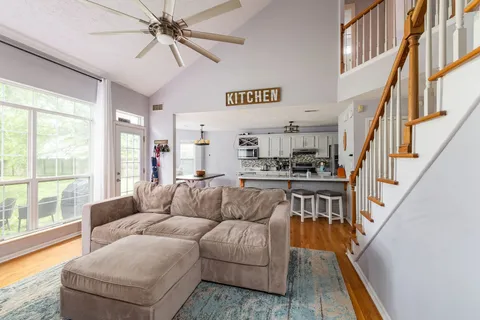 a living room with furniture and a kitchen view