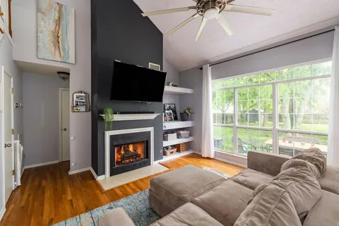 a living room with furniture a fireplace and a flat screen tv