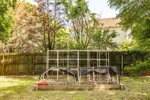 a view of a swimming pool with a patio and a yard