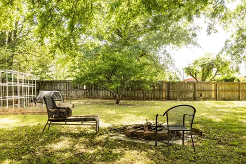 a swimming pool with outdoor seating and yard
