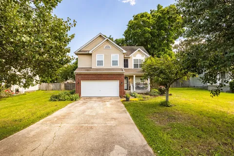 a front view of a house with yard