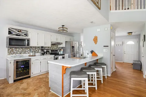 a kitchen with a stove a sink and a refrigerator