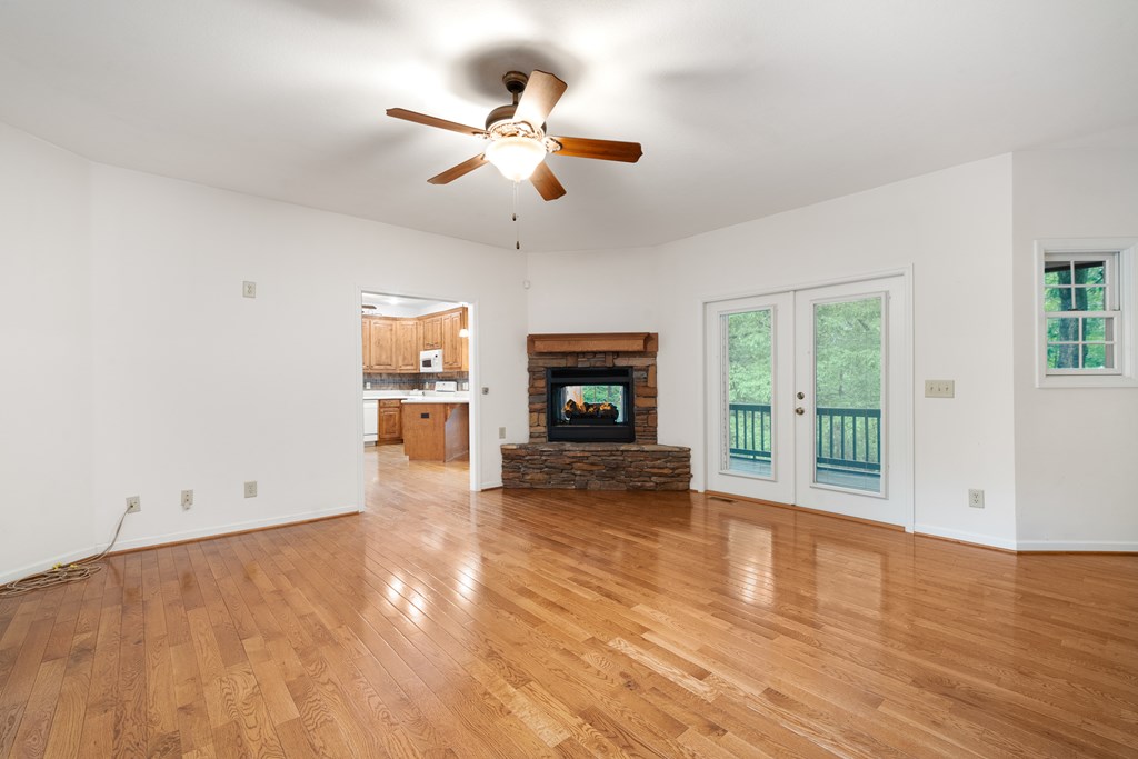 399 Hideaway Hills Road Blairsville, GA 30512 - Photo 36 of 77 a view of a livingroom with wooden floor a ceiling fan and windows