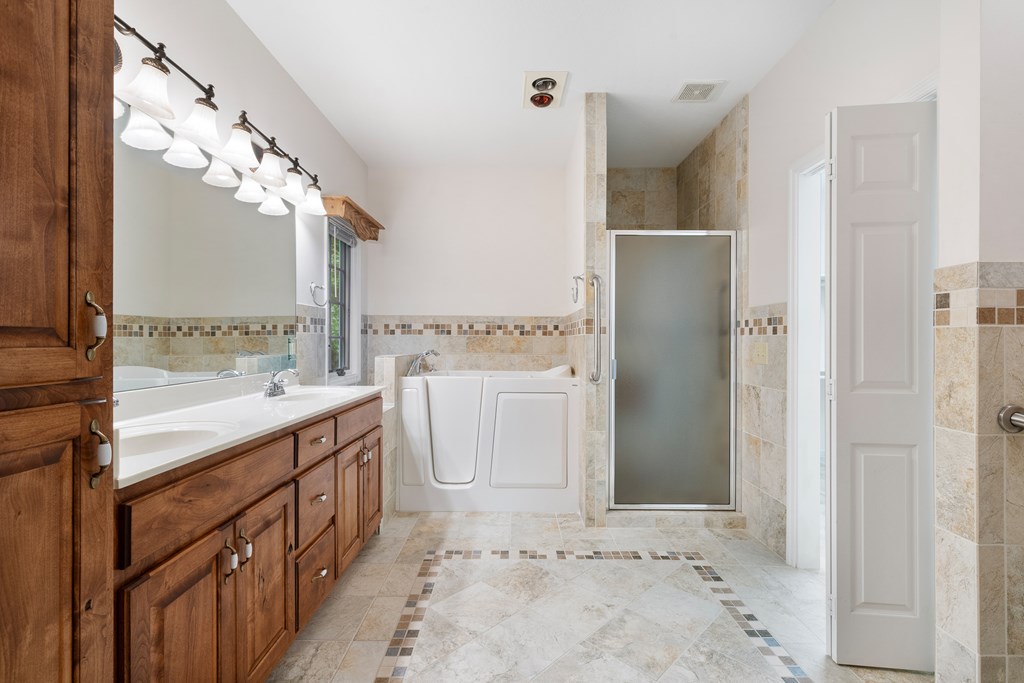 399 Hideaway Hills Road Blairsville, GA 30512 - Photo 40 of 77 a bathroom with a sink a mirror and a shower