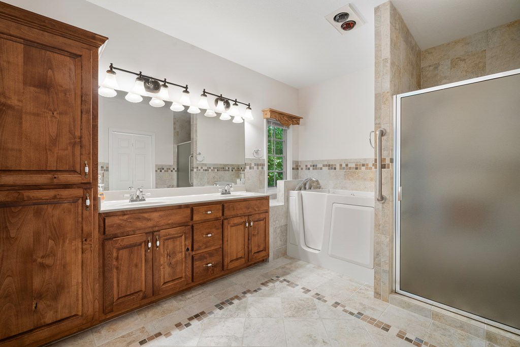 399 Hideaway Hills Road Blairsville, GA 30512 - Photo 41 of 77 a spacious bathroom with a sink mirror and a shower