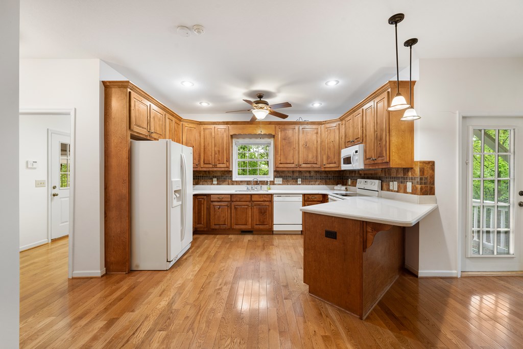 399 Hideaway Hills Road Blairsville, GA 30512 - Photo 44 of 77 a kitchen with refrigerator a sink and wooden floor