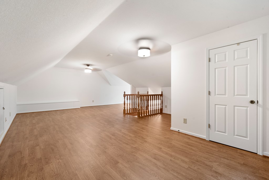 399 Hideaway Hills Road Blairsville, GA 30512 - Photo 58 of 77 an empty room with wooden floor and windows