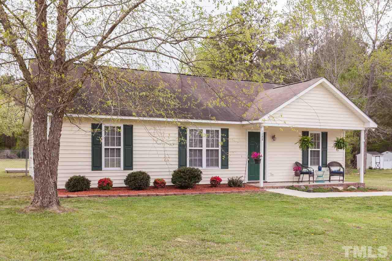 1388 Lee Road Clayton, NC 27520 - Photo 1 of 24 a view of a table and chairs in patio in front of house
