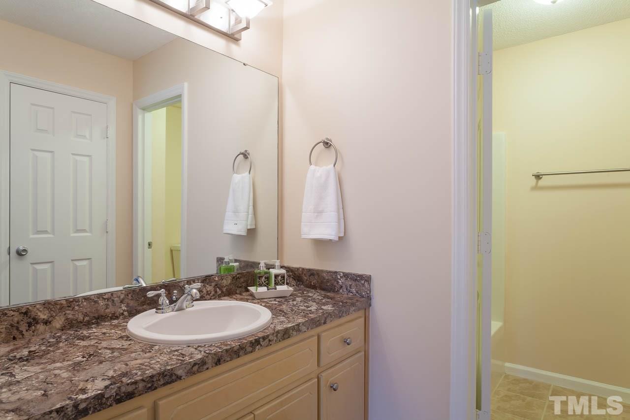 1388 Lee Road Clayton, NC 27520 - Photo 11 of 24 a bathroom with a granite countertop sink and a mirror
