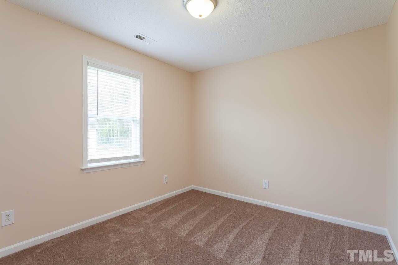 1388 Lee Road Clayton, NC 27520 - Photo 15 of 24 an empty room with a window