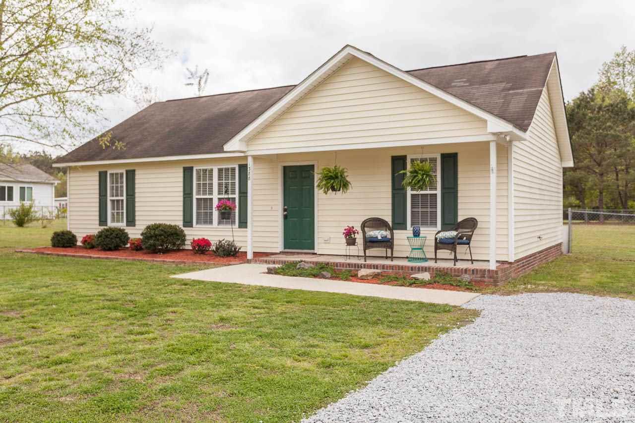 1388 Lee Road Clayton, NC 27520 - Photo 3 of 24 a front view of house with yard outdoor seating and yard
