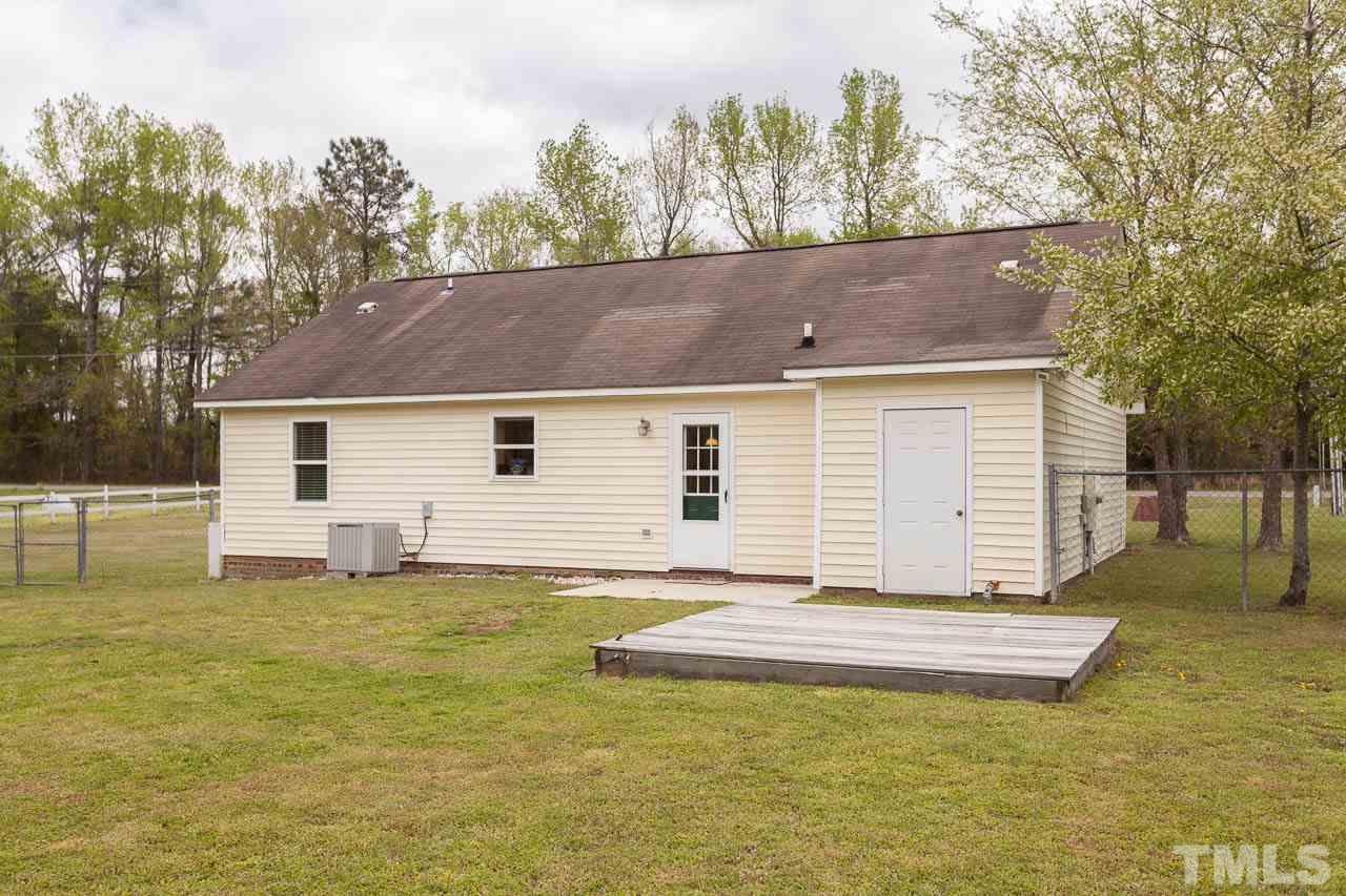 1388 Lee Road Clayton, NC 27520 - Photo 21 of 24 a view of a house with a yard and a tree