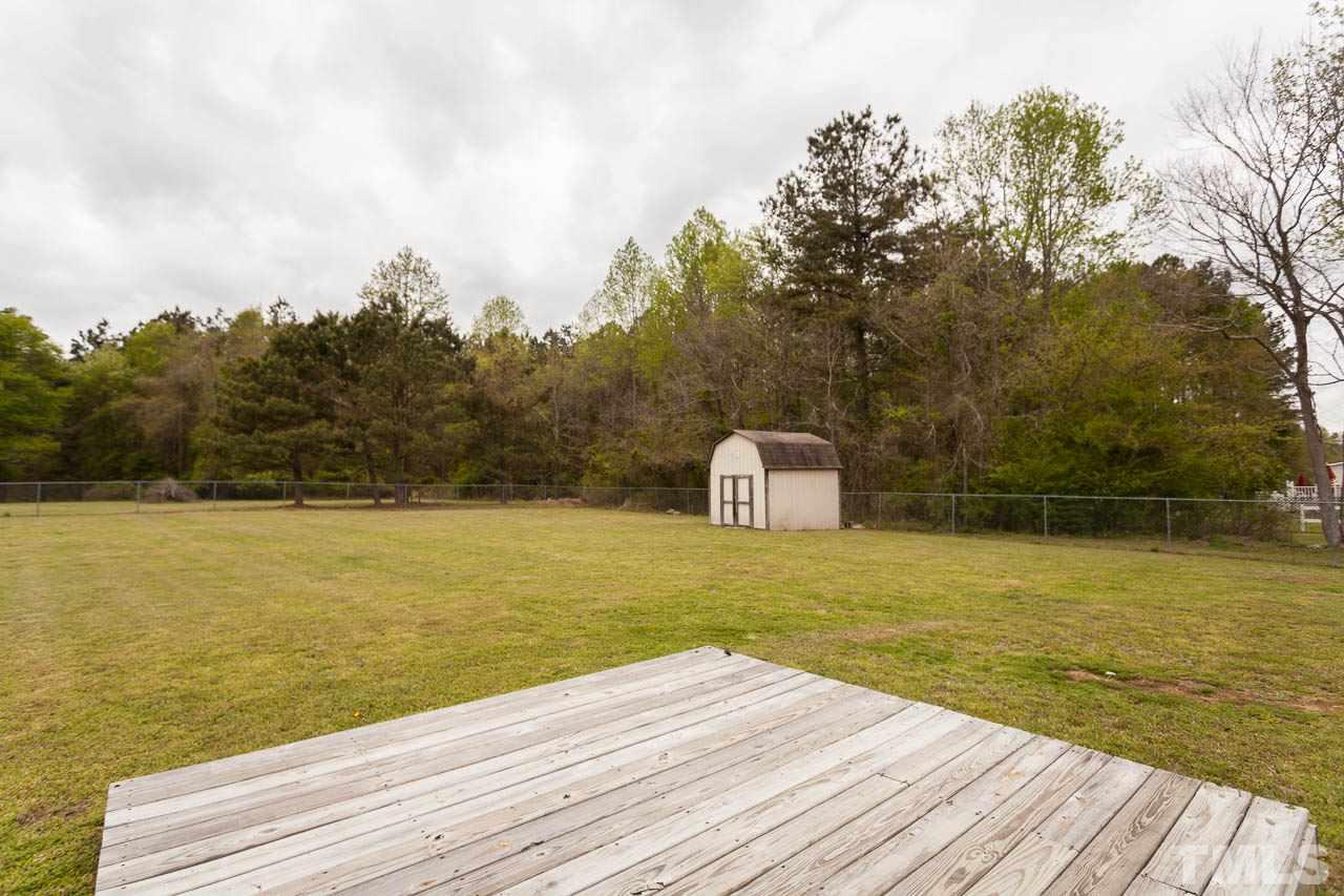 1388 Lee Road Clayton, NC 27520 - Photo 22 of 24 a view of a lake with a yard