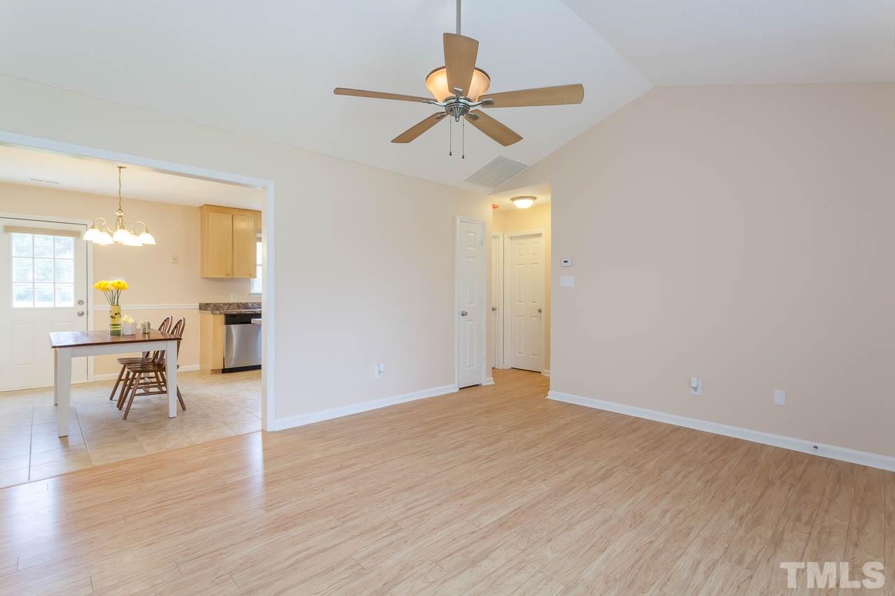 1388 Lee Road Clayton, NC 27520 - Photo 9 of 24 a view of a room with wooden floor and a ceiling fan