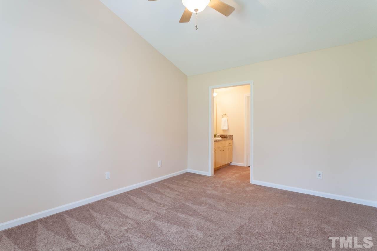 1388 Lee Road Clayton, NC 27520 - Photo 10 of 24 a view of an empty room with a ceiling fan