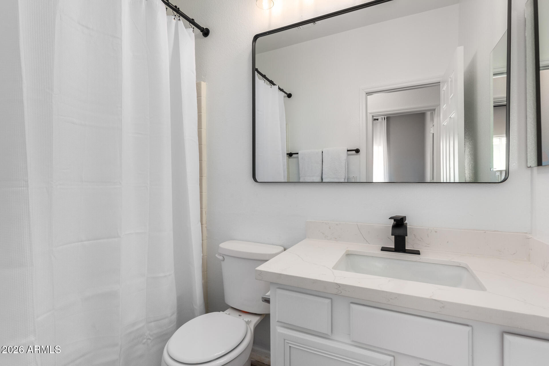 3674 South Joshua Tree Lane Gilbert, AZ 85297 - Photo 14 of 30 a bathroom with a toilet sink and mirror