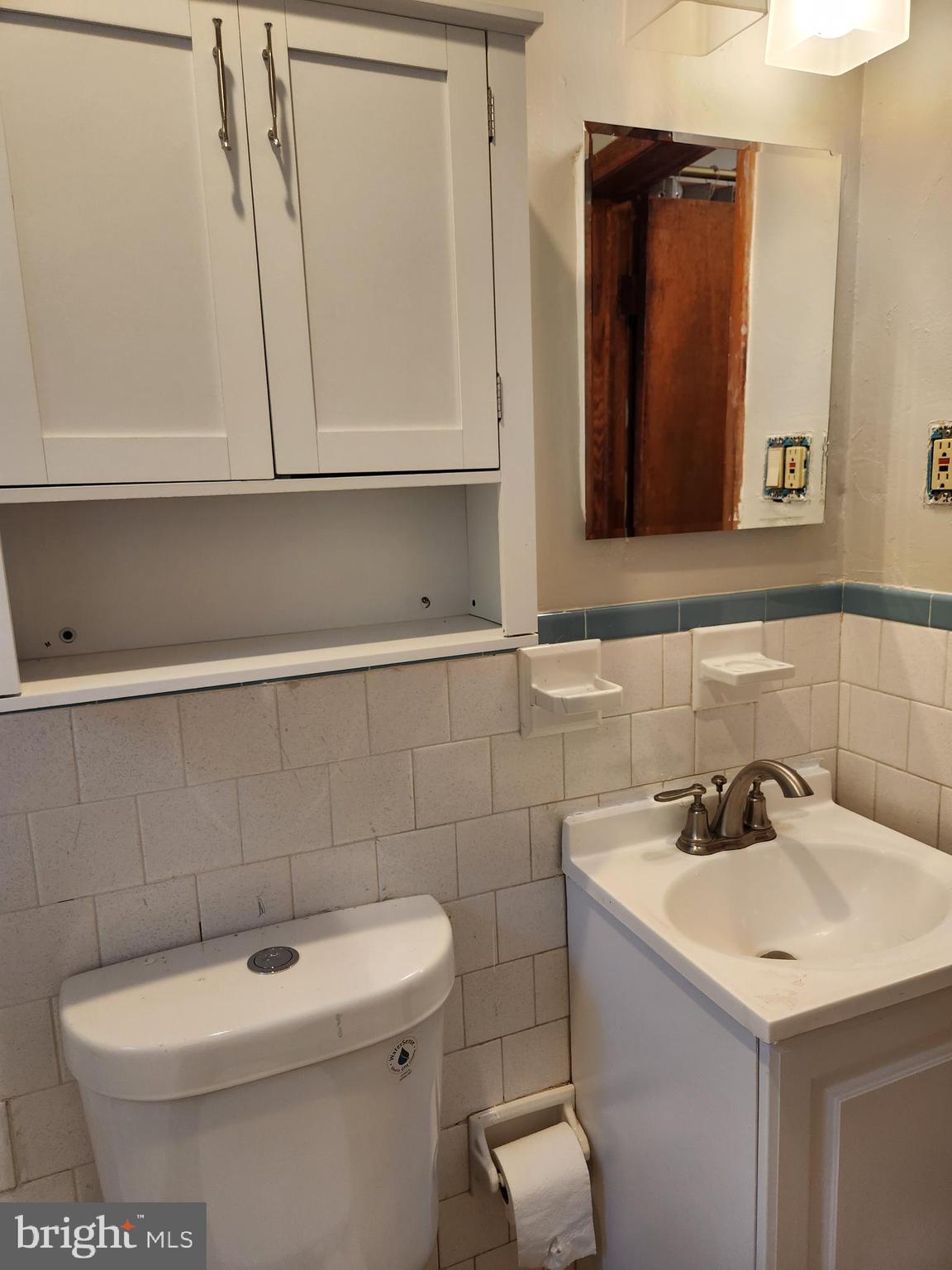 3817 Birchview Avenue, Unit 1 Baltimore, MD 21206 - Photo 11 of 19 a bathroom with a sink a toilet and mirror