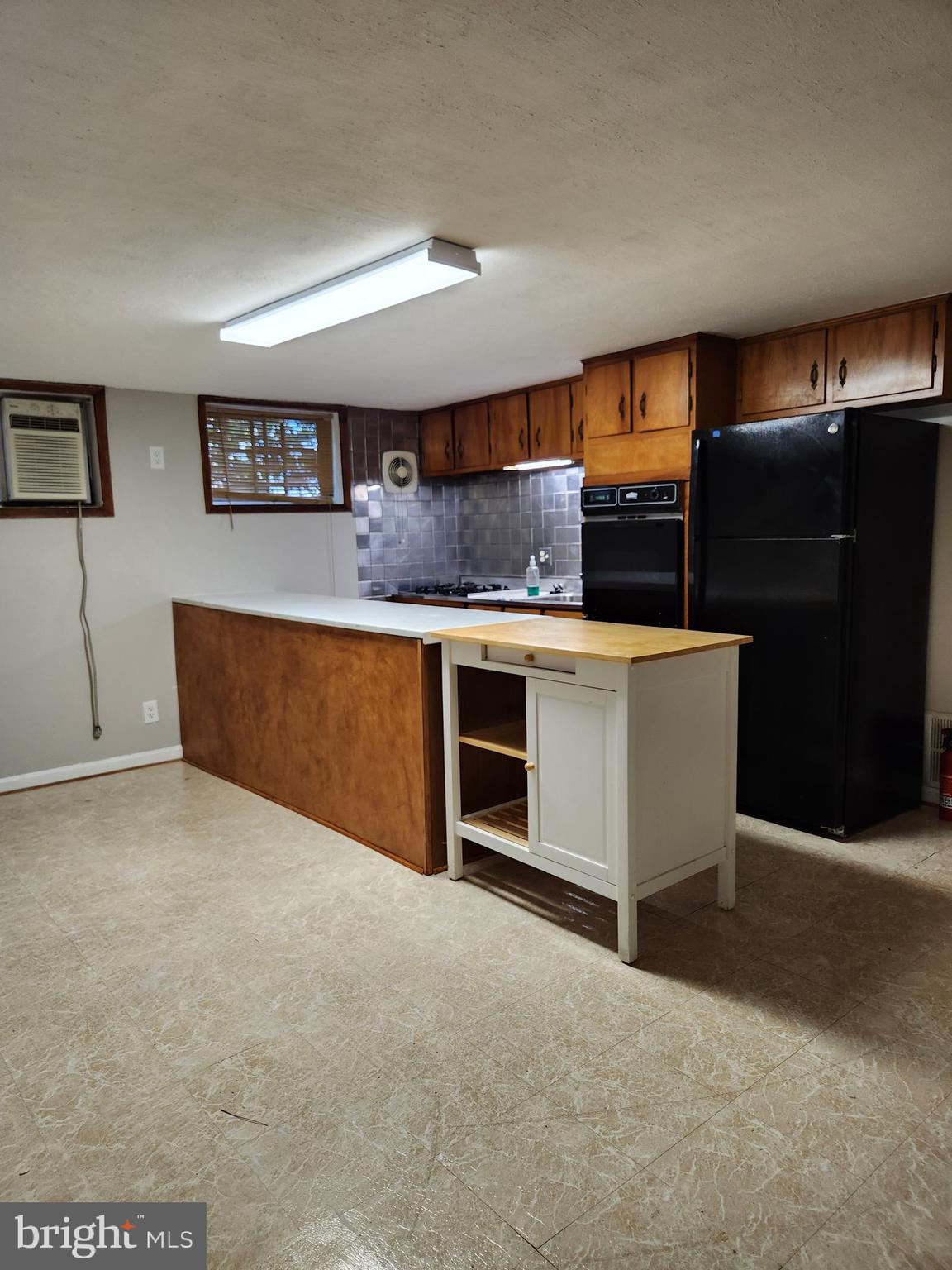 3817 Birchview Avenue, Unit 1 Baltimore, MD 21206 - Photo 14 of 19 a kitchen with stainless steel appliances a stove and more cabinets