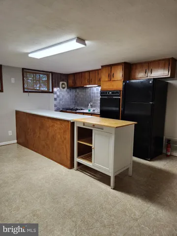 a kitchen with stainless steel appliances a stove and a refrigerator