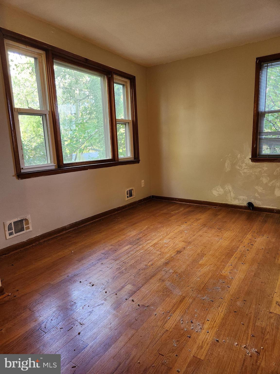 3817 Birchview Avenue, Unit 1 Baltimore, MD 21206 - Photo 4 of 19 an empty room with wooden floor and windows