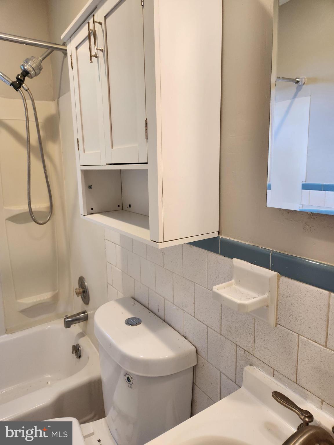 3817 Birchview Avenue, Unit 1 Baltimore, MD 21206 - Photo 10 of 19 a white toilet sitting next to a bath tub and a shower