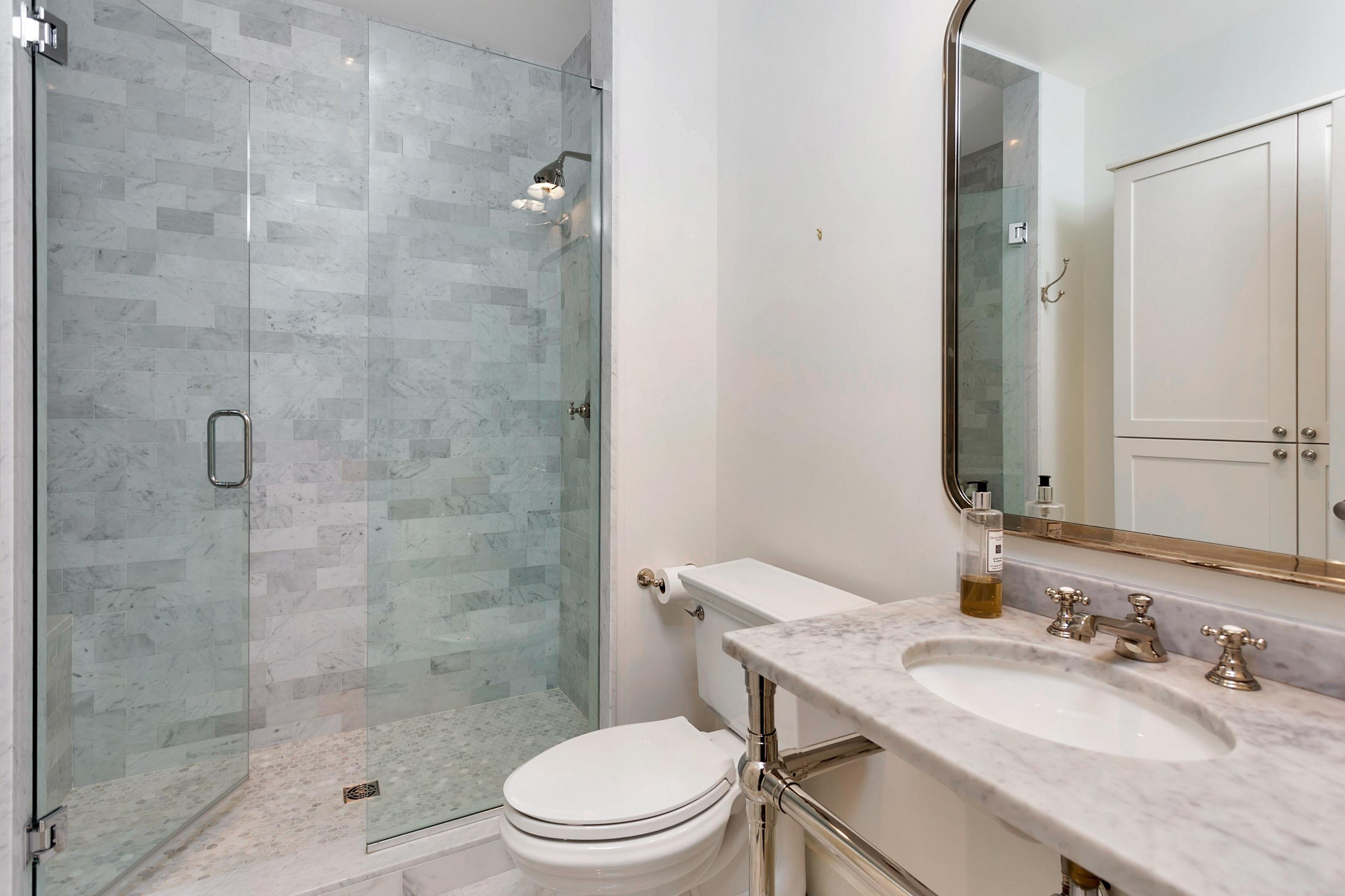 9 Searles Road Darien, CT 06820 - Photo 22 of 40 a bathroom with a sink a toilet and shower