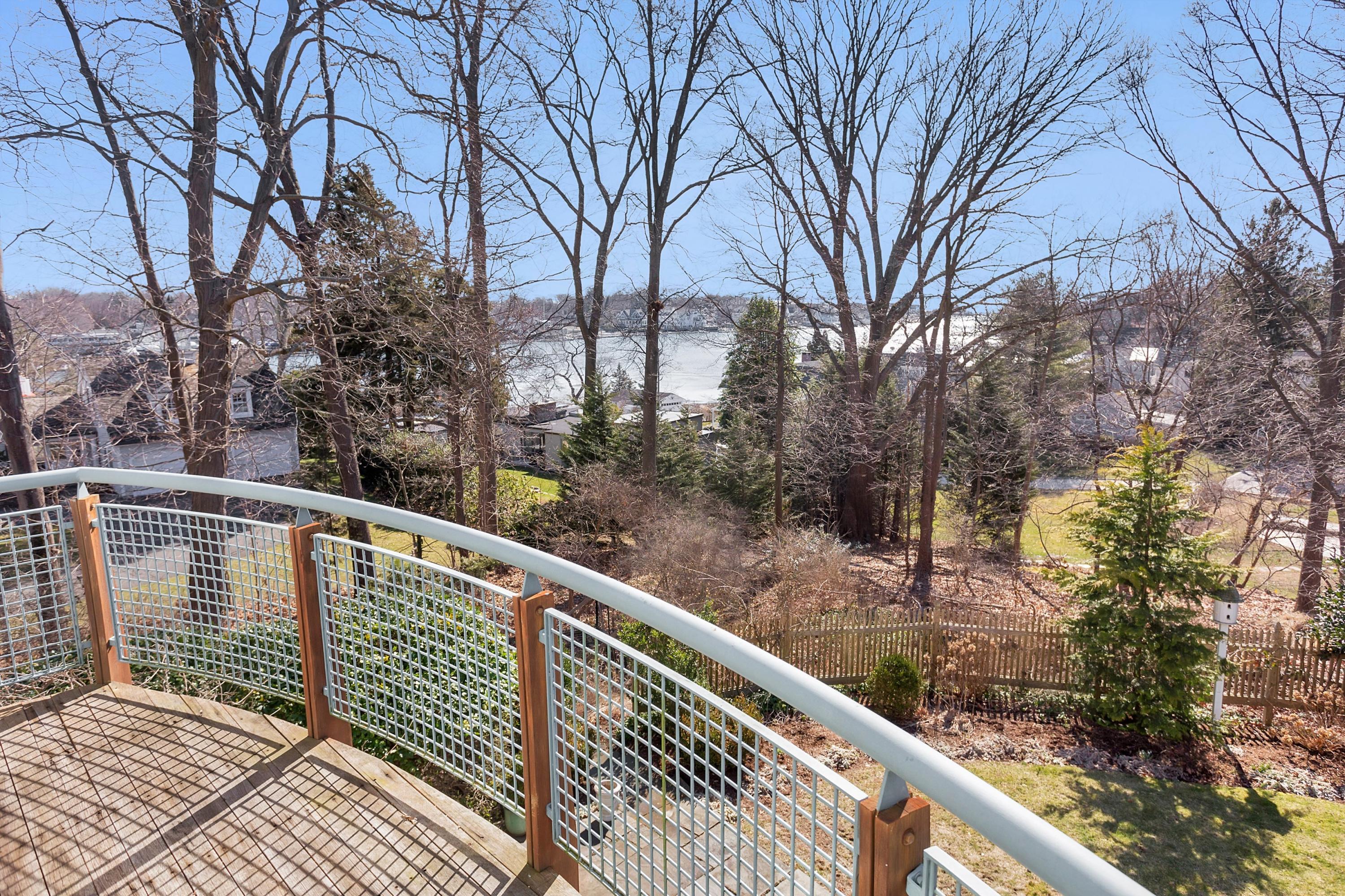 9 Searles Road Darien, CT 06820 - Photo 26 of 40 a balcony with wooden floor and fence