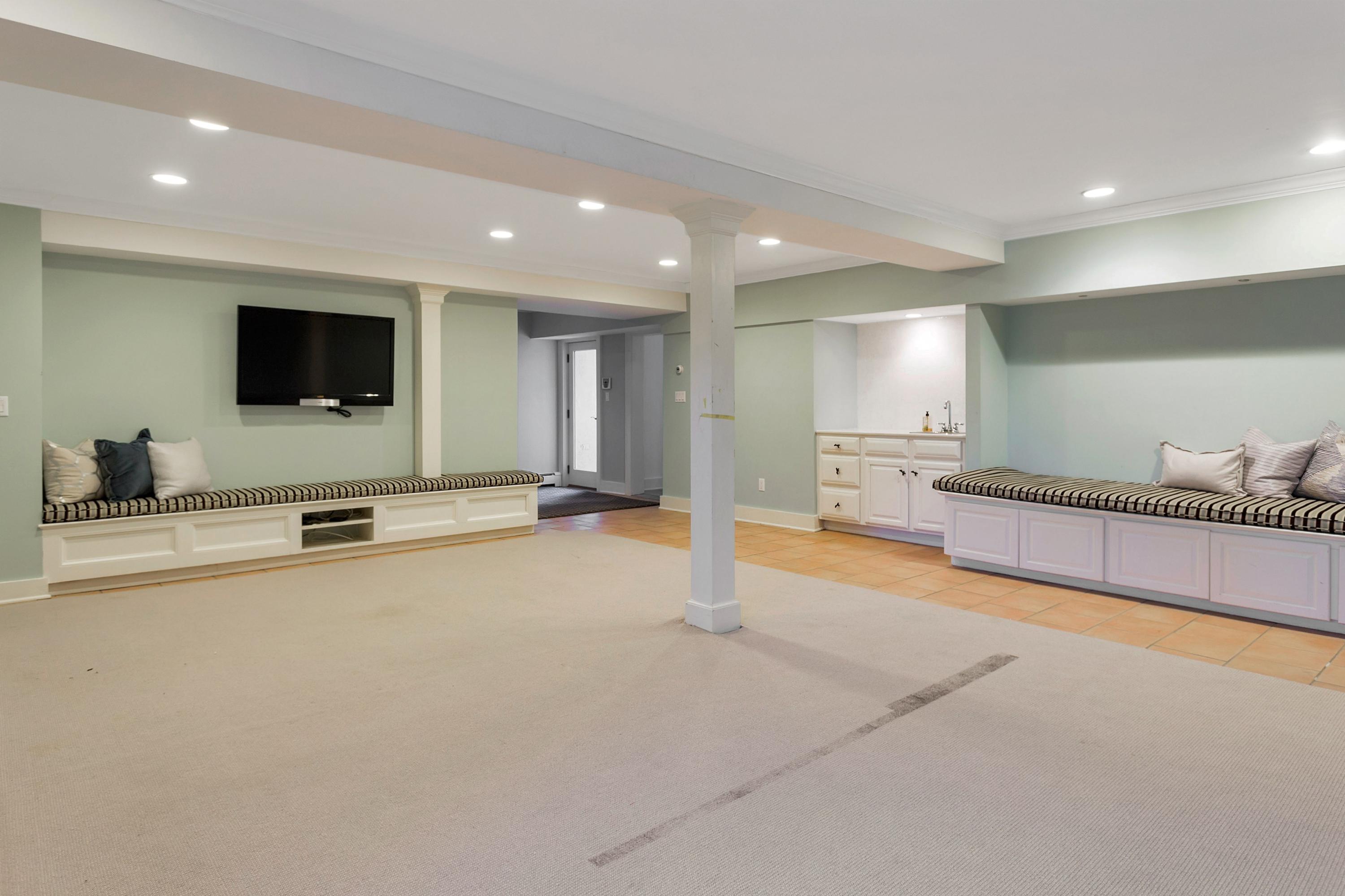 9 Searles Road Darien, CT 06820 - Photo 32 of 40 a view of a room with gym equipment and a flat screen tv