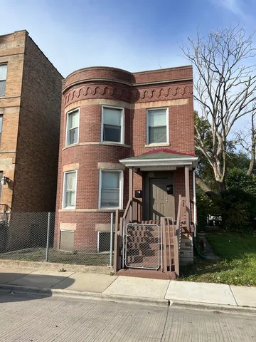 a view of a brick building with large windows