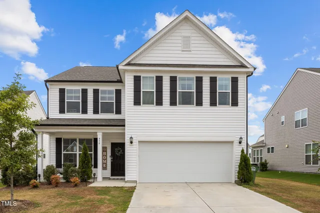 a view of a white house with large windows